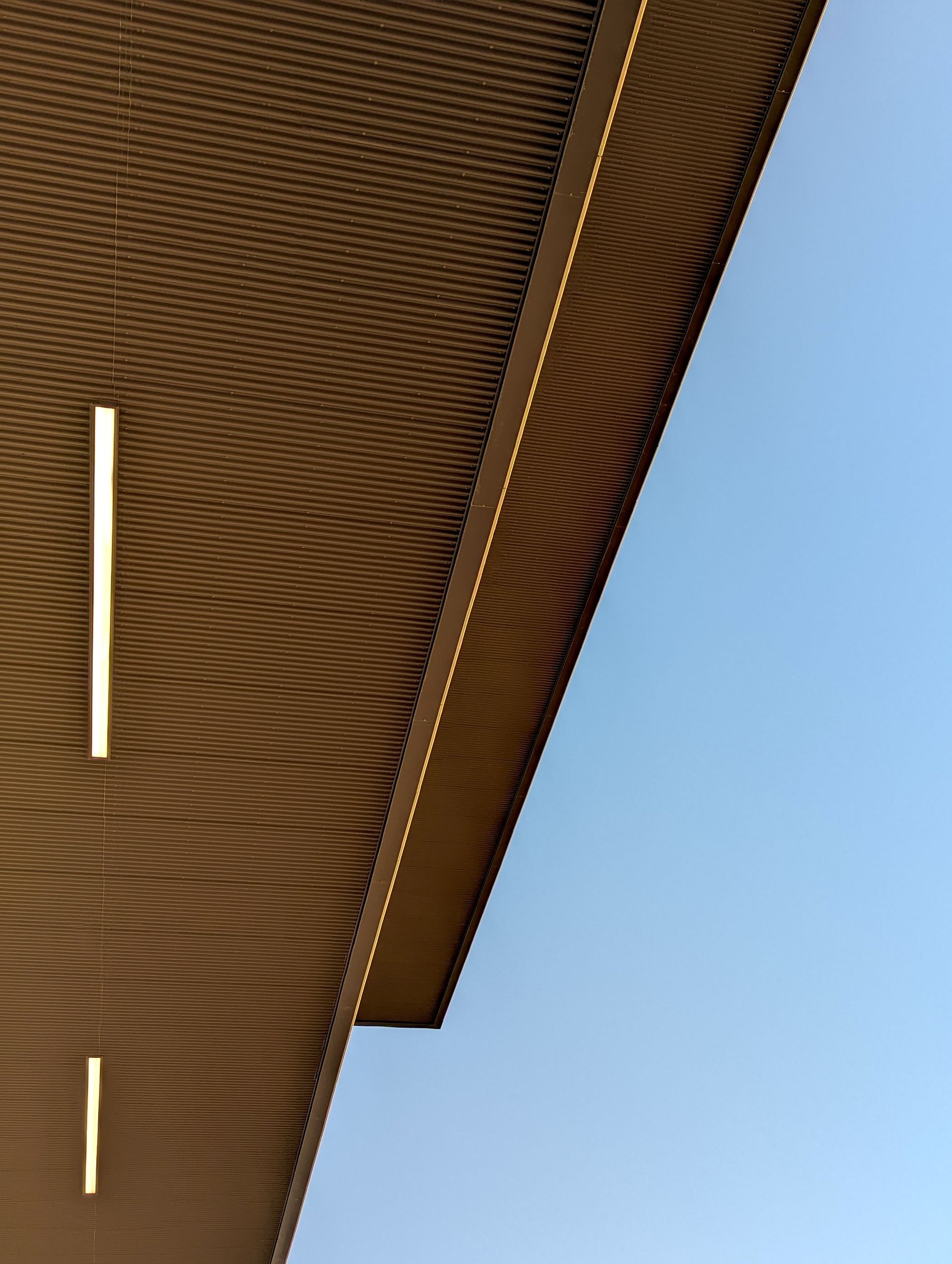 Minimalist architectural design captured at dusk, featuring clean geometric lines and a calm atmosphere.